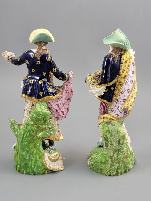 fig 2. A pair of 19th-century Bloor Derby porcelain figurines depicting a shepherdess with a lamb and a shepherd with a dog, painted in multi-coloured enamels with gilded Rococo scroll bases.