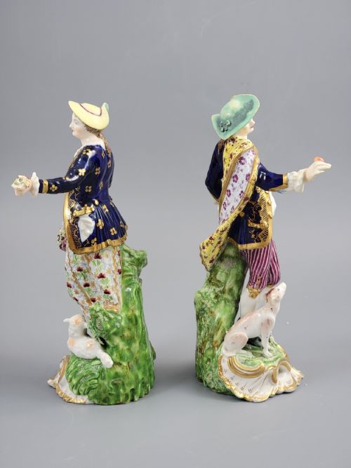 fig 3. A pair of 19th-century Bloor Derby porcelain figurines depicting a shepherdess with a lamb and a shepherd with a dog, painted in multi-coloured enamels with gilded Rococo scroll bases.