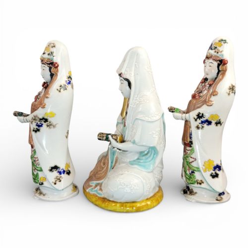 fig 1. A set of three late nineteenth-century Japanese Kutani porcelain figures depicting Kannon flanked by two standing attendants, finished in white glaze with gilded and polychrome enamelled robes.