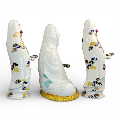 fig 3. A set of three late nineteenth-century Japanese Kutani porcelain figures depicting Kannon flanked by two standing attendants, finished in white glaze with gilded and polychrome enamelled robes.