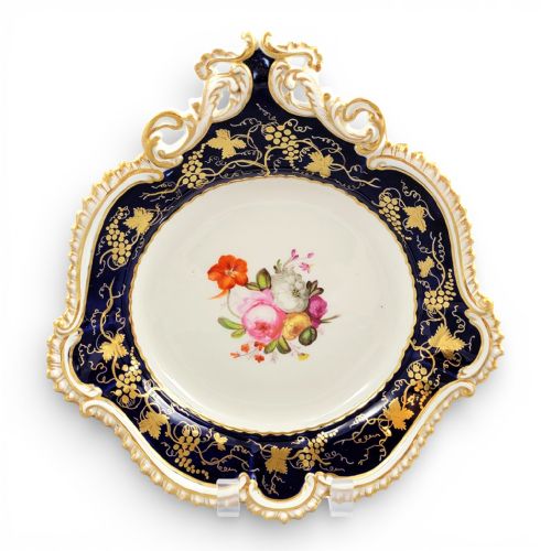 fig 1. A pair of shaped English porcelain serving dishes featuring cobalt blue rims with gilded foliage patterns and hand-painted central floral bouquets.
