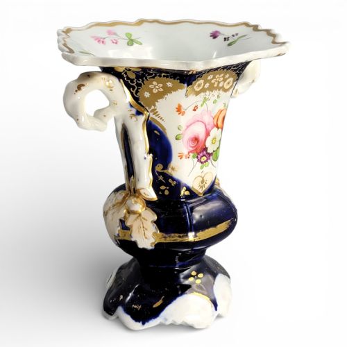 fig 3. An early nineteenth-century French porcelain vase featuring hand-painted pink floral motifs, cobalt blue glaze, twin scroll handles, and gold leaf embellishments.