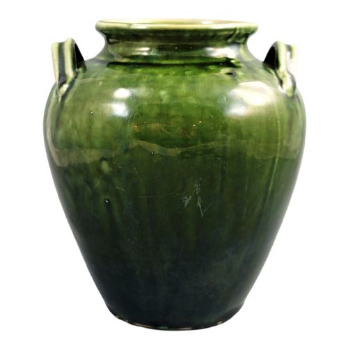 fig 1. A 19th-century French green glazed terracotta confit jar featuring two handles near the flared rim.