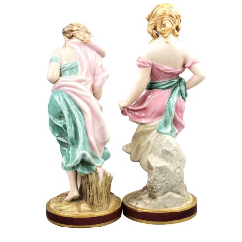 fig 2. A pair of Victorian Royal Worcester porcelain figures depicting draped maidens with pink and green dresses standing on circular bases.