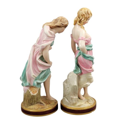 fig 3. A pair of Victorian Royal Worcester porcelain figures depicting draped maidens with pink and green dresses standing on circular bases.
