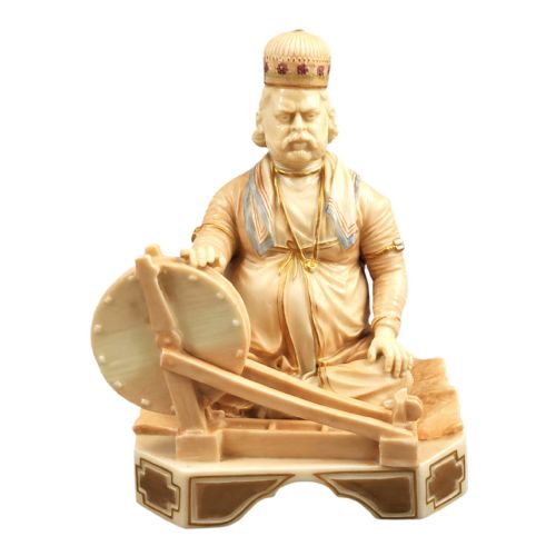 fig 3. A late 19th-century Royal Worcester blush ivory porcelain figurine depicting an Indian craftsman seated at a spinning wheel, detailed with polychrome enamel and gold gilded highlights.