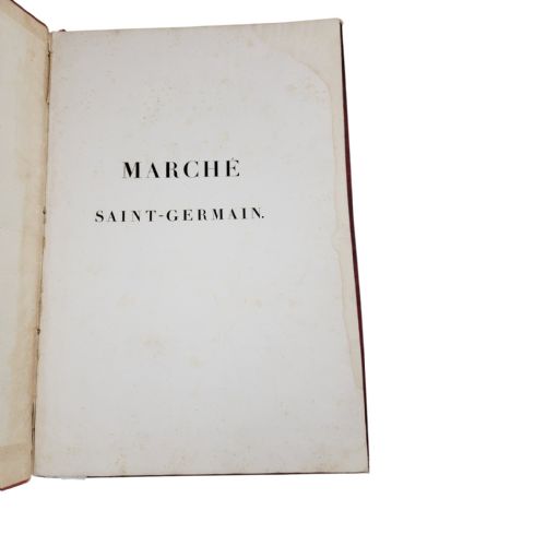 fig 1. A red leather-bound nineteenth-century book featuring decorative gilt tooling around the rectangular border.