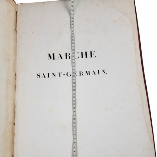 fig 2. A red leather-bound nineteenth-century book featuring decorative gilt tooling around the rectangular border.
