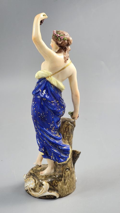 fig 2. A nineteenth-century Samson Paris porcelain figure of a Bacchante wearing a patterned cobalt blue drape and holding grapes on a scrollwork base.