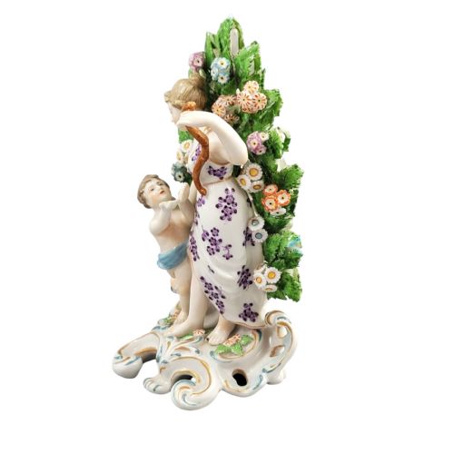 fig 1. A 19th-century Samson porcelain figurine depicting Venus and Cupid standing in front of a floral leaf bocage on a gilded scroll base.