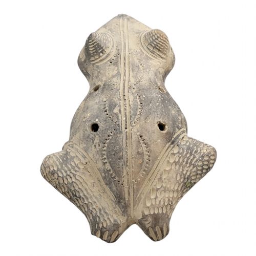 fig 2. A sculpted grey earthenware whistle shaped like a frog with incised line details and finger holes along its back.
