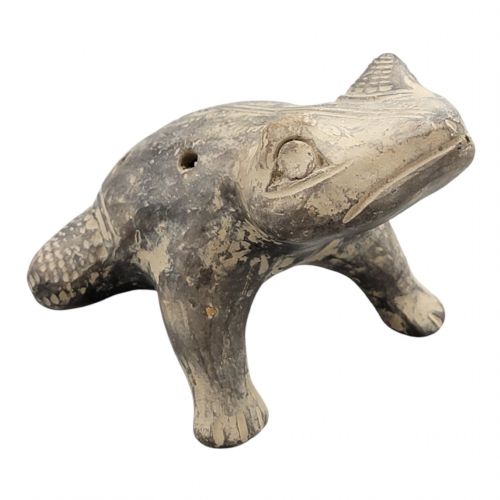 fig 4. A sculpted grey earthenware whistle shaped like a frog with incised line details and finger holes along its back.