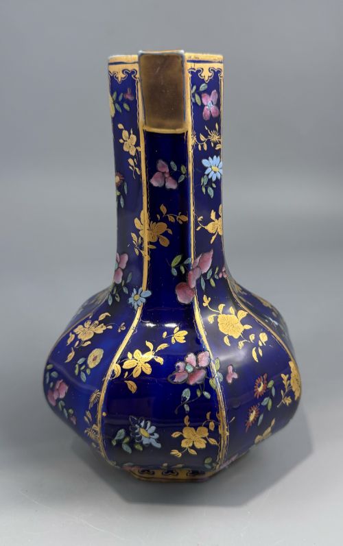 fig 1. An octagonal cobalt blue ironstone ewer decorated with hand-painted Chinoiserie floral patterns and a gilded grotesque animal form handle.