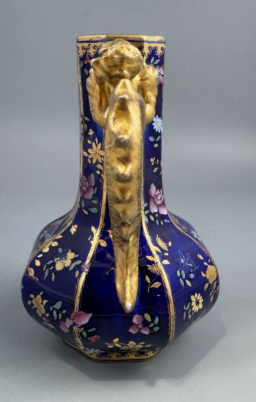 fig 3. An octagonal cobalt blue ironstone ewer decorated with hand-painted Chinoiserie floral patterns and a gilded grotesque animal form handle.