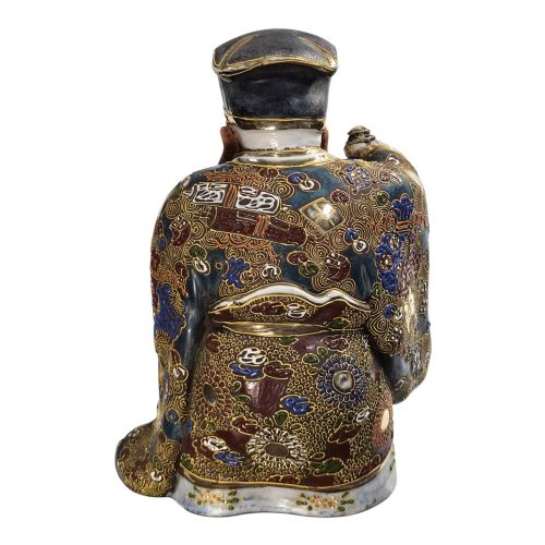 fig 3. A Japanese Kutani porcelain figurine depicting Jurojin with a long white beard holding a staff, decorated in polychrome overglaze enamels and gold details.
