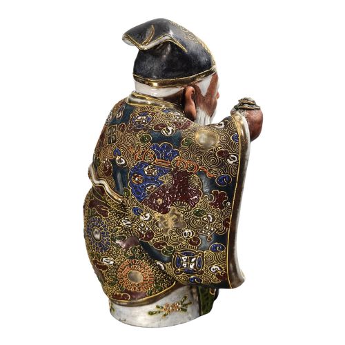 fig 4. A Japanese Kutani porcelain figurine depicting Jurojin with a long white beard holding a staff, decorated in polychrome overglaze enamels and gold details.