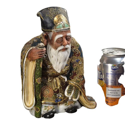 fig 5. A Japanese Kutani porcelain figurine depicting Jurojin with a long white beard holding a staff, decorated in polychrome overglaze enamels and gold details.