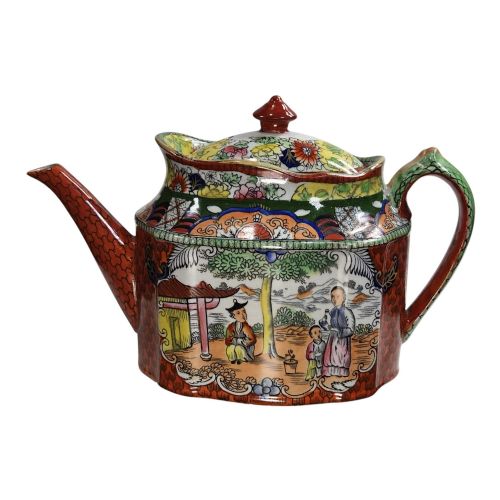 fig 1. An antique Masons ironstone oval teapot featuring a red scale pattern and a hand-painted Chinoiserie scene with figures.