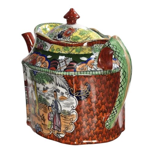 fig 2. An antique Masons ironstone oval teapot featuring a red scale pattern and a hand-painted Chinoiserie scene with figures.