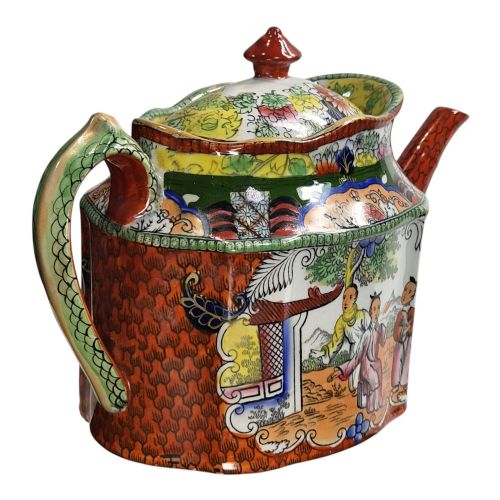 fig 3. An antique Masons ironstone oval teapot featuring a red scale pattern and a hand-painted Chinoiserie scene with figures.