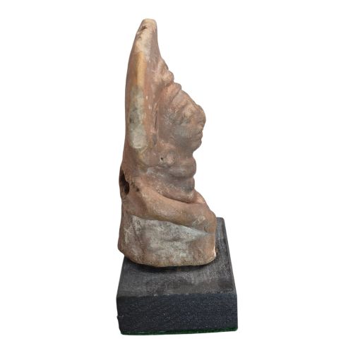 fig 3. A Pre-Columbian earthenware terracotta sculpture depicting a seated female figure with a flared headdress, mounted on a rectangular dark wooden base.