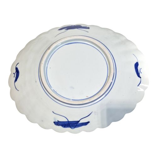 fig 4. A pair of round antique Japanese Arita Imari porcelain charger plates featuring scalloped edges, fan motifs, landscape scenes, and iron red, cobalt blue, and green enamels.
