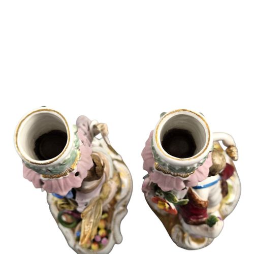 fig 4. A pair of late nineteenth-century Volkstedt polychrome porcelain allegorical candlesticks depicting classical figures representing Summer and Autumn on rococo scroll bases.