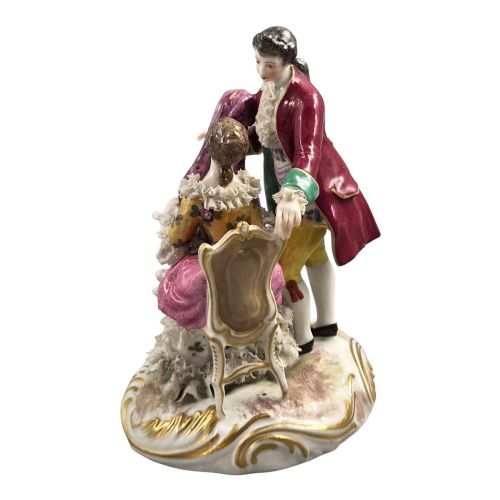 fig 2. A 19th-century Paris porcelain figural group depicting a man standing behind a seated woman playing a harp, featuring porcelain lace trim and gold scrollwork.
