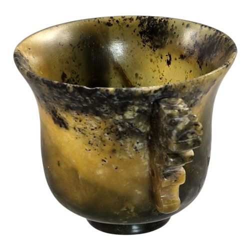 fig 4. A hand-carved mottled olive-green and dark ochre nephrite jade cup featuring carved handles on either side.