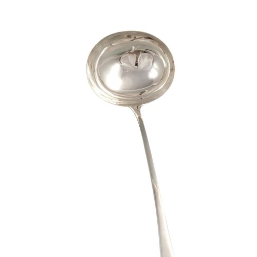 fig 2. A Georgian sterling silver soup ladle featuring a deep circular bowl, a long curved stem in the Old English pattern, and an engraved crest near the handle tip.