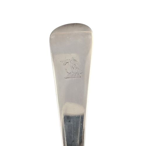fig 4. A Georgian sterling silver soup ladle featuring a deep circular bowl, a long curved stem in the Old English pattern, and an engraved crest near the handle tip.