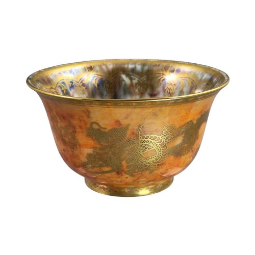 fig 1. An antique ceramic bowl with a mottled orange lustre glaze on the exterior, decorated with a gold gilded dragon, and a pearlescent interior with a gilded scalloped border.