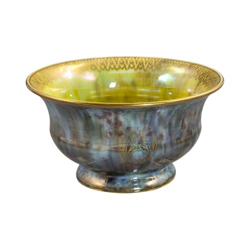 fig 1. An iridescent blue footed porcelain bowl with gilded dragon motifs and a patterned gold interior rim.