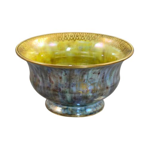 fig 2. An iridescent blue footed porcelain bowl with gilded dragon motifs and a patterned gold interior rim.