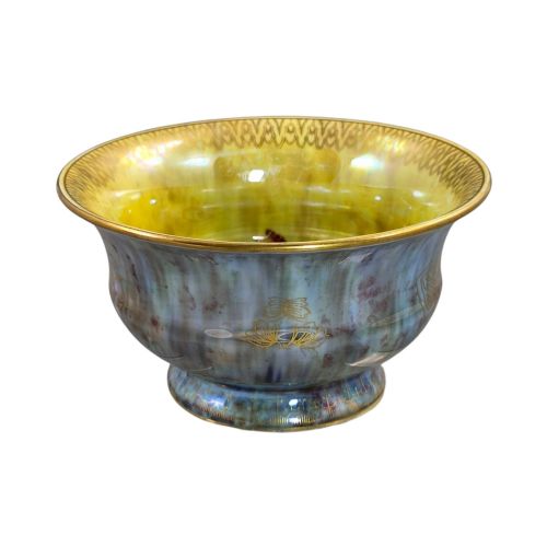 fig 3. An iridescent blue footed porcelain bowl with gilded dragon motifs and a patterned gold interior rim.