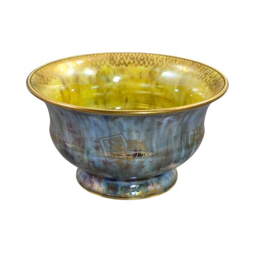 fig 4. An iridescent blue footed porcelain bowl with gilded dragon motifs and a patterned gold interior rim.