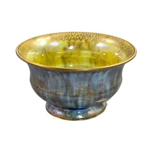 fig 5. An iridescent blue footed porcelain bowl with gilded dragon motifs and a patterned gold interior rim.