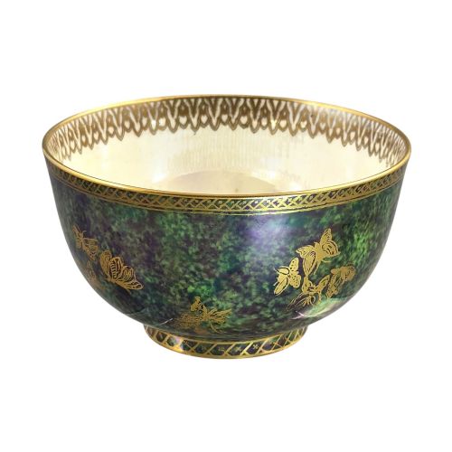 fig 4. A deep porcelain bowl featuring a mottled green iridescent exterior decorated with gilded butterflies and geometric gold borders around the rim and base.