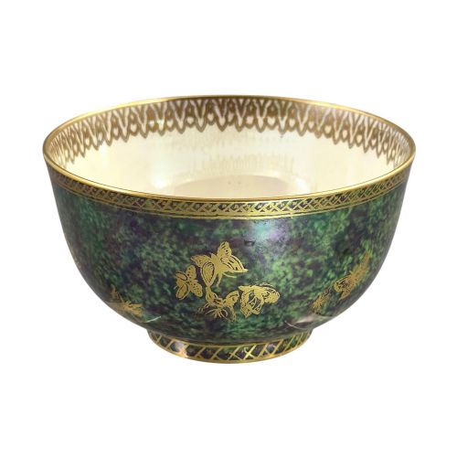 fig 5. A deep porcelain bowl featuring a mottled green iridescent exterior decorated with gilded butterflies and geometric gold borders around the rim and base.