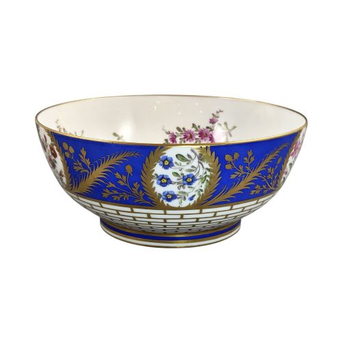 fig 4. A late 19th-century Samson hard-paste porcelain footed bowl featuring a cobalt blue band with gilded leaf details, hand-painted floral cartouches, and a white brick-patterned base.