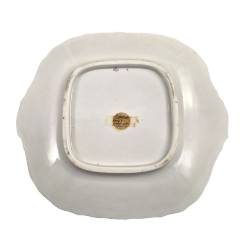 fig 4. A pair of early Victorian Coalport porcelain square dessert dishes featuring hand-painted floral centres, beige borders with gold scrollwork, and moulded twin handles.