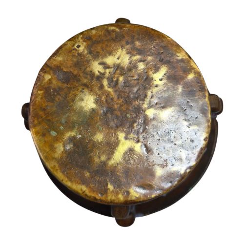 fig 3. A heavy 17th-century cast bronze apothecary mortar featuring raised heraldic coat of arms motifs and side lugs around a flared rim.