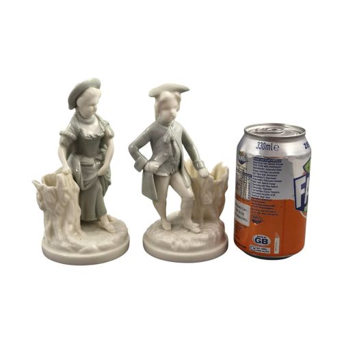 fig 4. A pair of late Victorian grey and cream glazed porcelain figural salts depicting a man and woman beside hollow tree stump vessels.