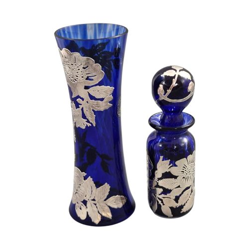 fig 1. A cobalt blue glass vase and matching perfume bottle with stopper, both featuring intricate sterling silver floral overlay.