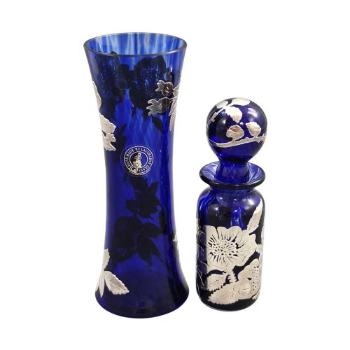 fig 2. A cobalt blue glass vase and matching perfume bottle with stopper, both featuring intricate sterling silver floral overlay.