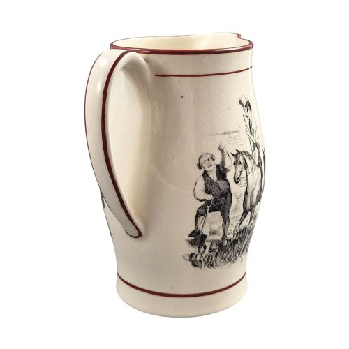 fig 4. A Georgian creamware jug featuring a black transfer-printed hunting scene and terracotta red painted rim accents against a cream glaze.