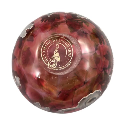 fig 3. A three-piece ruby red glass vanity set featuring floral sterling silver overlay details across two stoppered bottles and a cylindrical beaker.