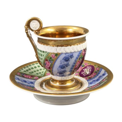 fig 2. A nineteenth-century French Vieux Paris porcelain cabinet cup and matching saucer featuring gold gilding, multi-coloured hand-painted panels, and a high-loop lion mask handle.