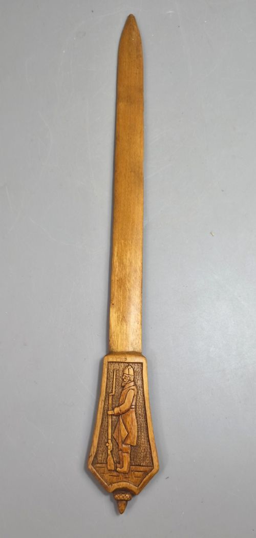 A hand-carved wooden letter opener featuring a relief carving of a soldier on the handle and carved text reading Krasnojarsk Sziberia 1916 on the blade. View VII
