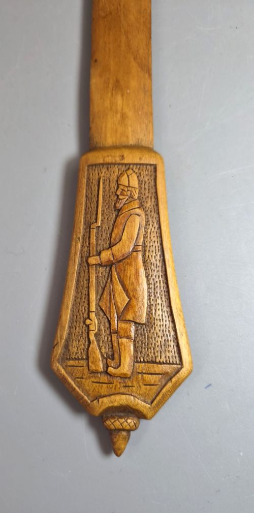 A hand-carved wooden letter opener featuring a relief carving of a soldier on the handle and carved text reading Krasnojarsk Sziberia 1916 on the blade. View VIII